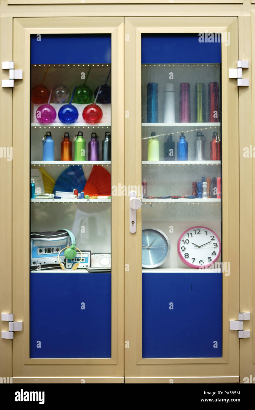 A Showcase Or Glass Cabinet With Dishes Plastic Bottles And Retro