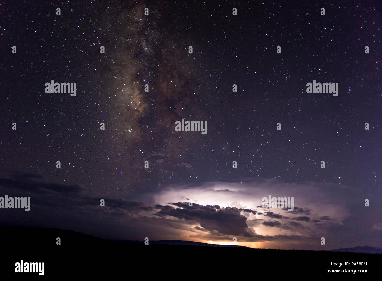 Milky Way, Stars, and storm clouds in Big Bend National Park Stock Photo