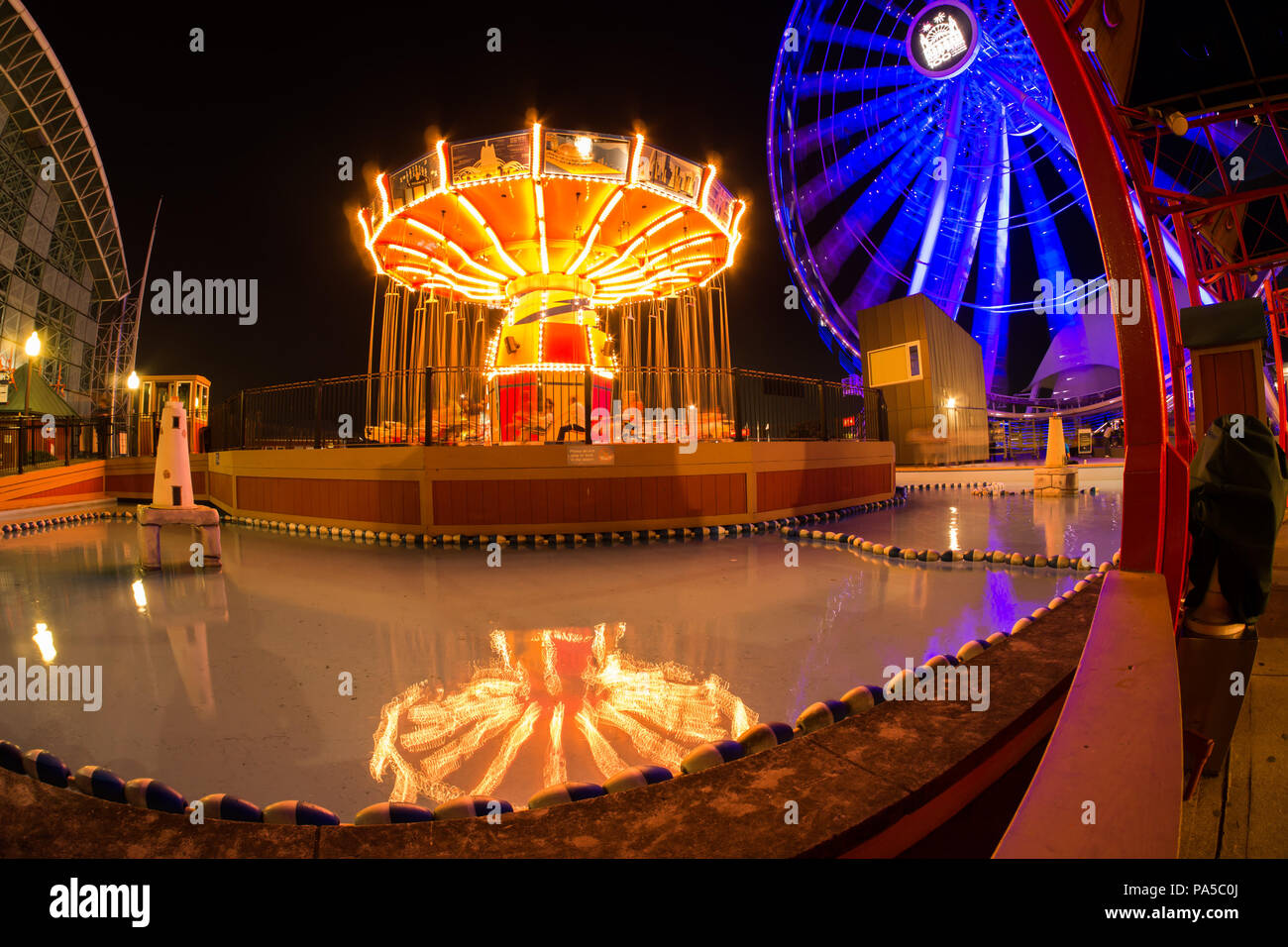 Colorful, dynamic night time lapse photo of amusement rides at night at ...