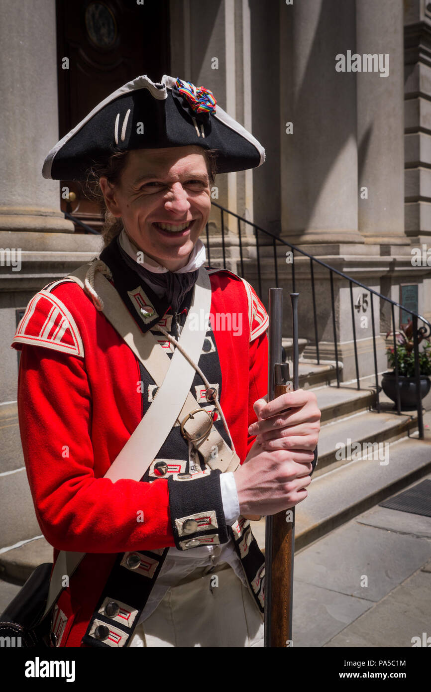 Young British Revolutionary War actor wearing red coat black hat with big smile on a summer day along the Freedom Trail in Boston. Stock Photo