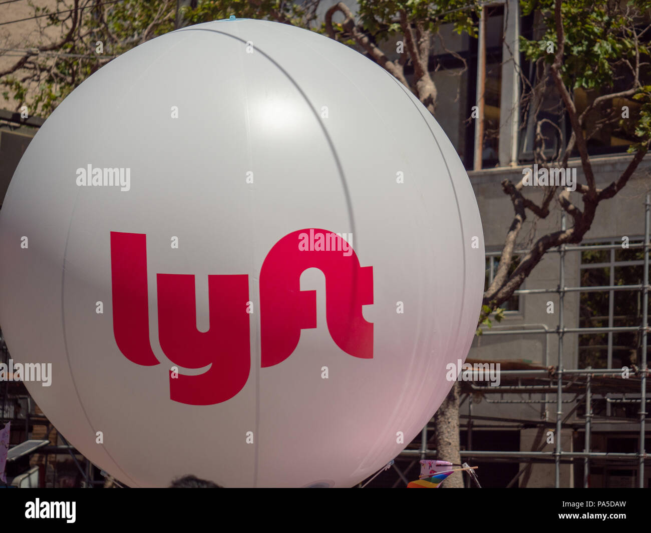 Large white Lyft balloon waving in an urban setting   Stock Photo
