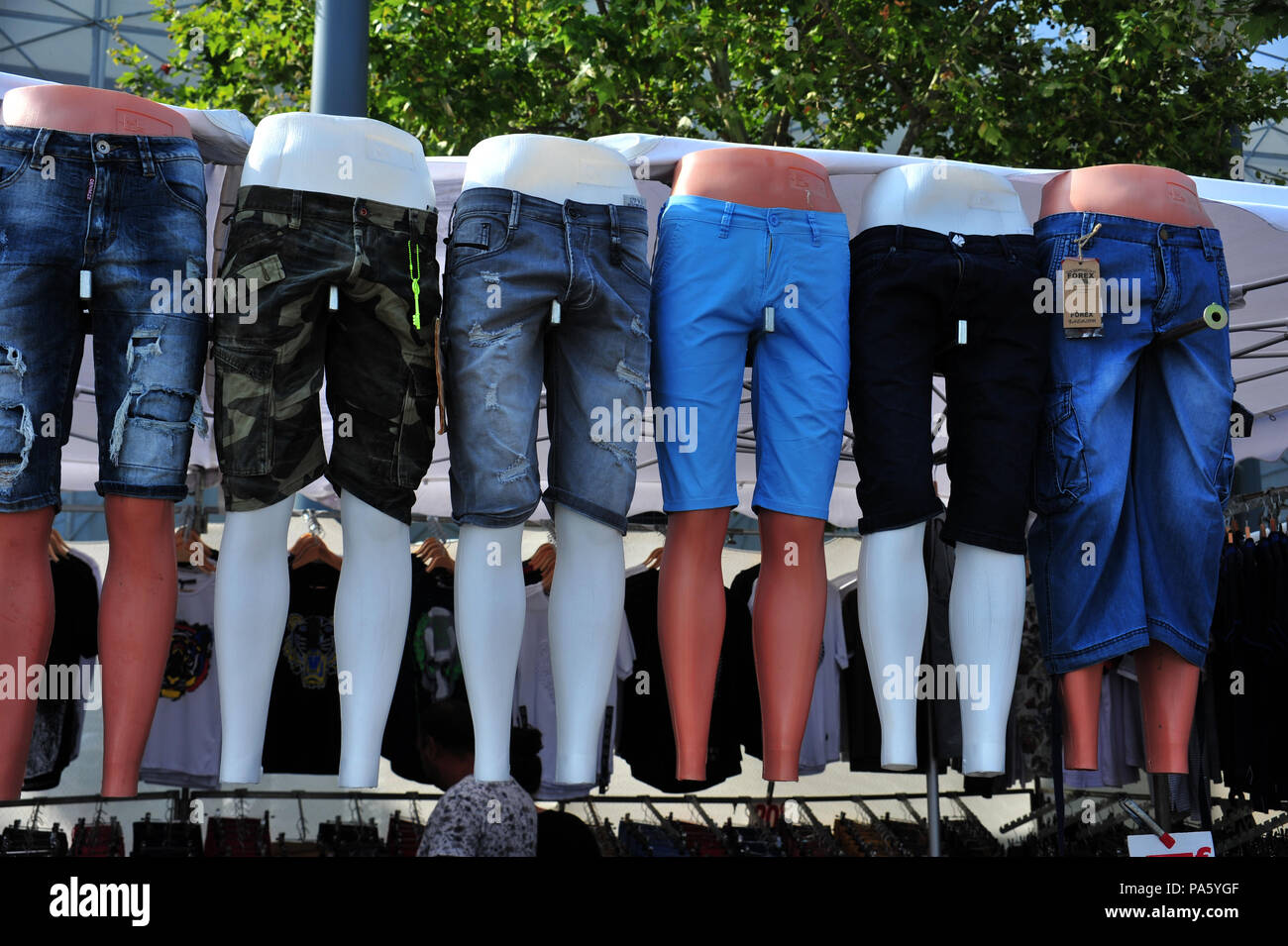 Row of mannequins wearing cut off jeans at a clothes market in Beziers, France Stock Photo Alamy