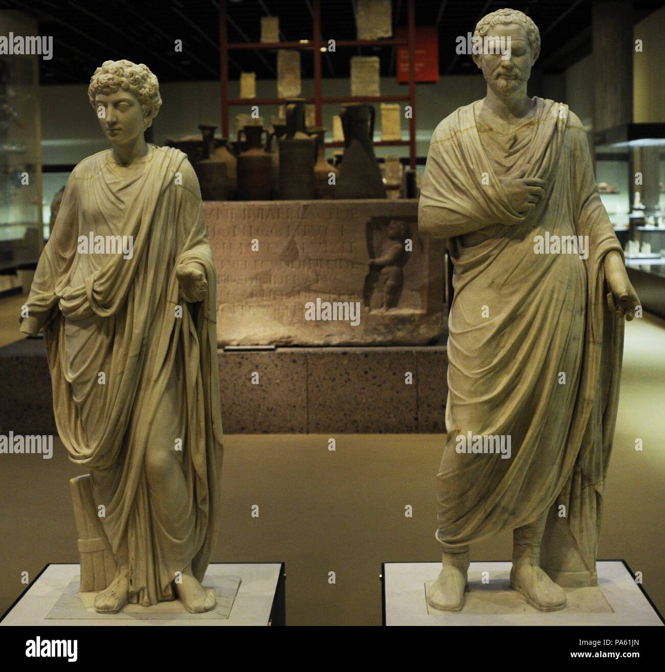On the left, statue of a Roman citizen of the 2nd century. The head of a young Marcus Aurelius was added later by a Neo-classical sculptor. On the right, statue of a Roman citizen from the end of the 1st century BC, during the Republic Period. The head was later added to depict Demosthenes (384-322 BC). Marble. Roman-Germanic Museum. Cologne. Germany. Stock Photo