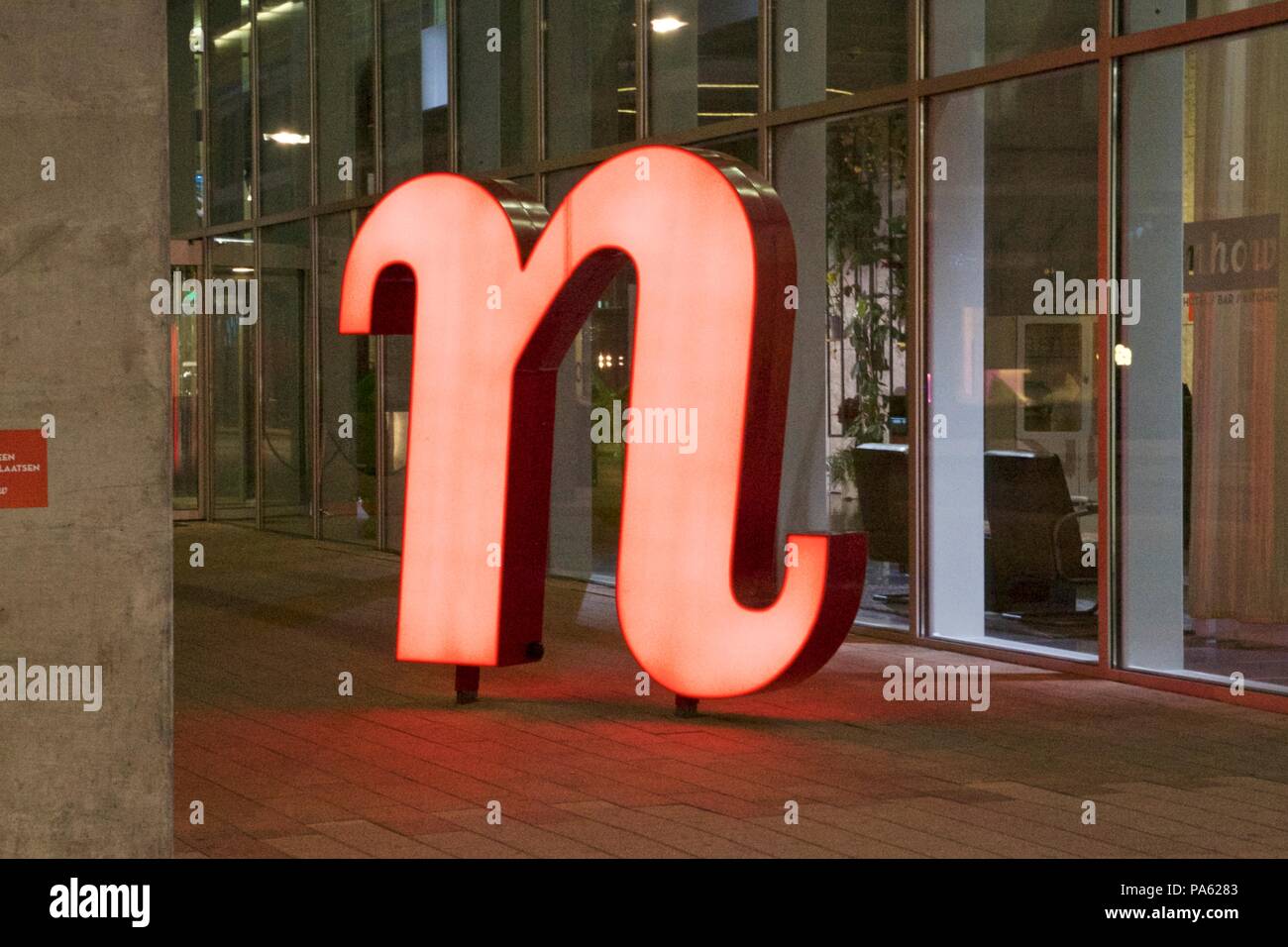 A red n statue sign outside nhow Rotterdam, part of NH Hotels Stock Photo
