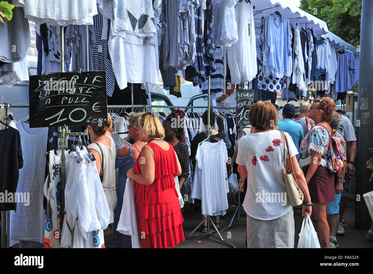 People shopping at the busy Friday clothes french market held each week in  Beziers, France Stock Photo - Alamy