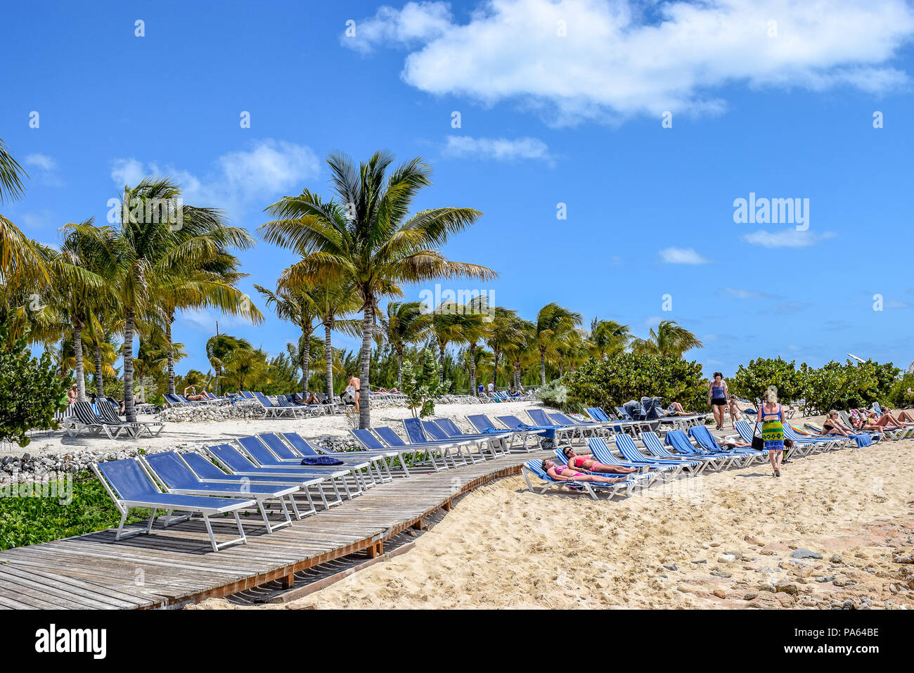 Grand Turk, Turks and Caicos Islands - April 03 2014: Beach goers sunbathing at Cruise Center Beach (SunRay Beach) in Grand Turk. Stock Photo