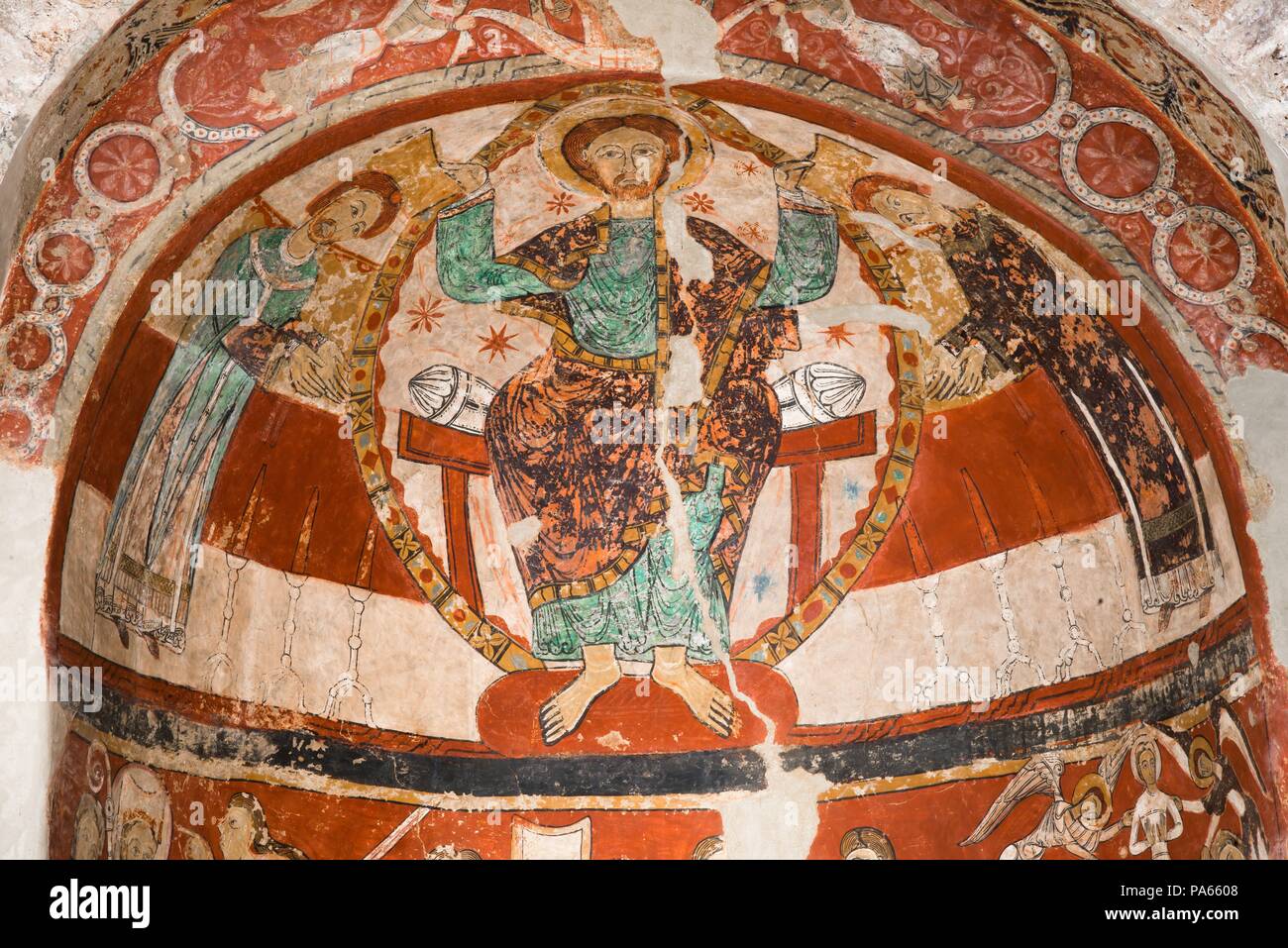 Mural painting in the absidal basin of the apse of the church of Santa María de Terrassa, representing Christ and two characters (possibly Tomás Becket and Edward Grim), Xth Century, Terrassa, Barcelona, Catalonia, Spain. Stock Photo