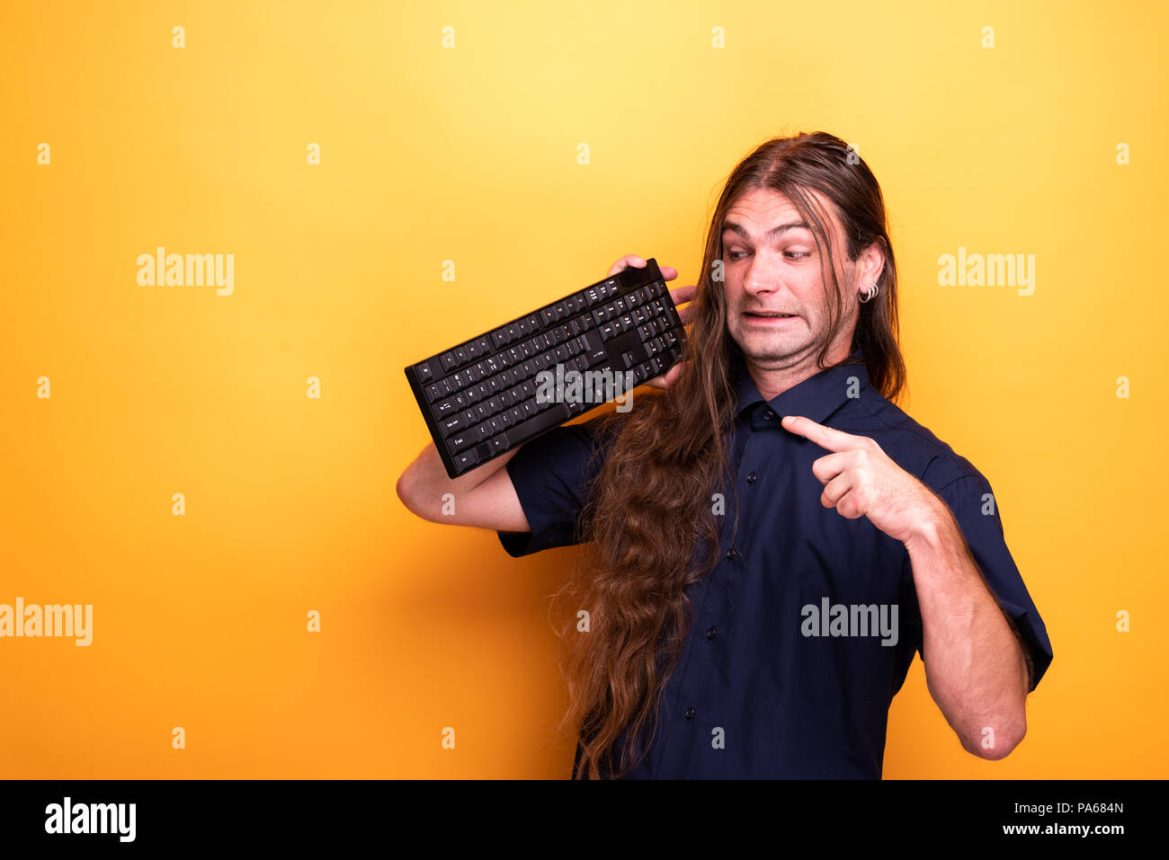Crazy male adult pointing to a keyboard Stock Photo