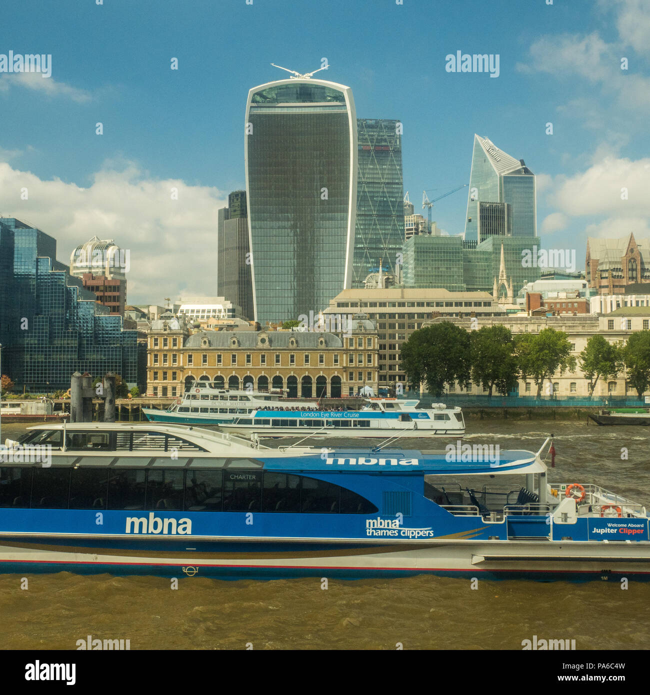 River boats on the Thames with the 'Walkie Talkie' Skyscaper (That houses the Sky Garden) behind Stock Photo