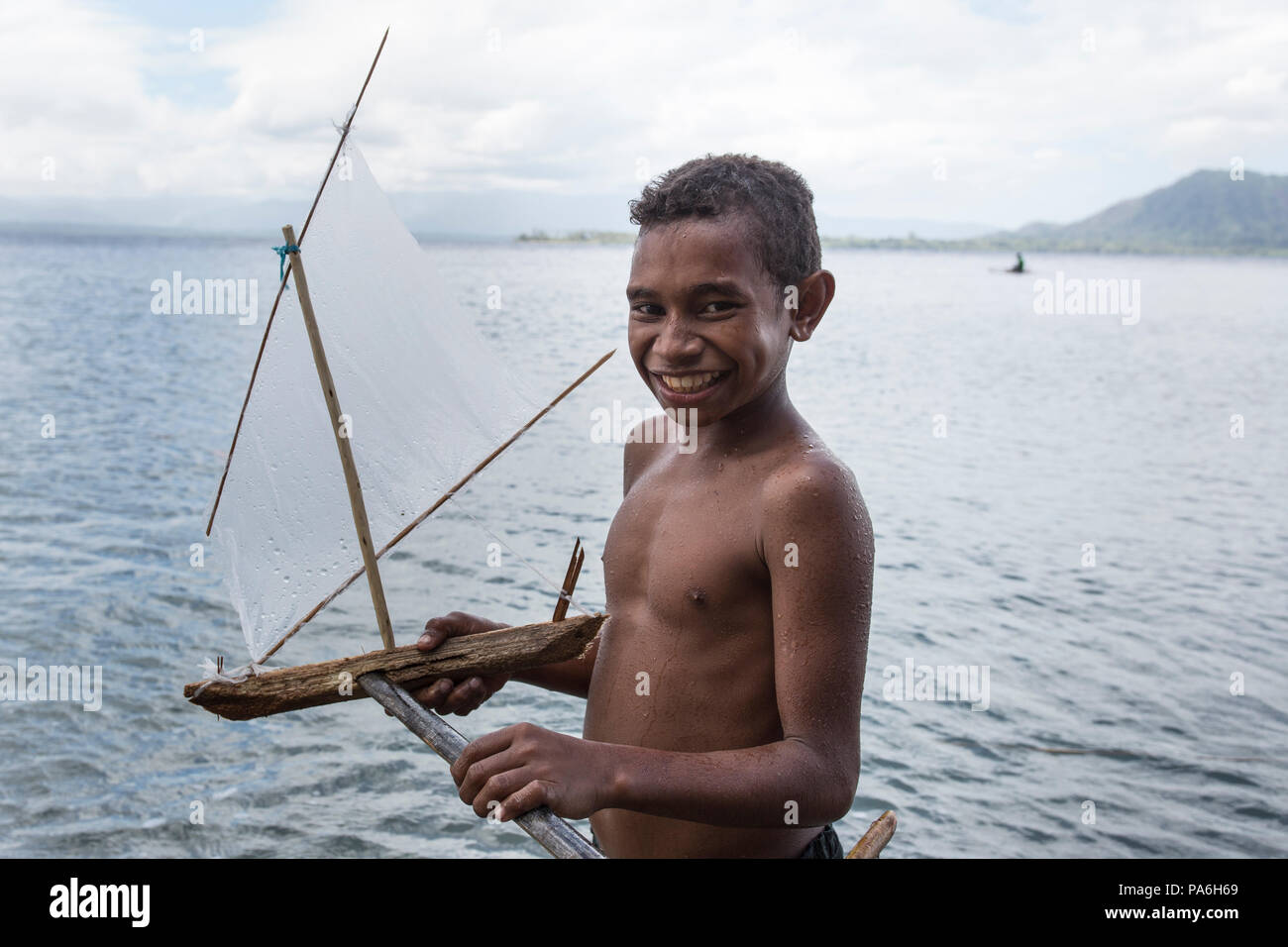 Boy with handmade toy boat, Papua New Guinea Stock Photo