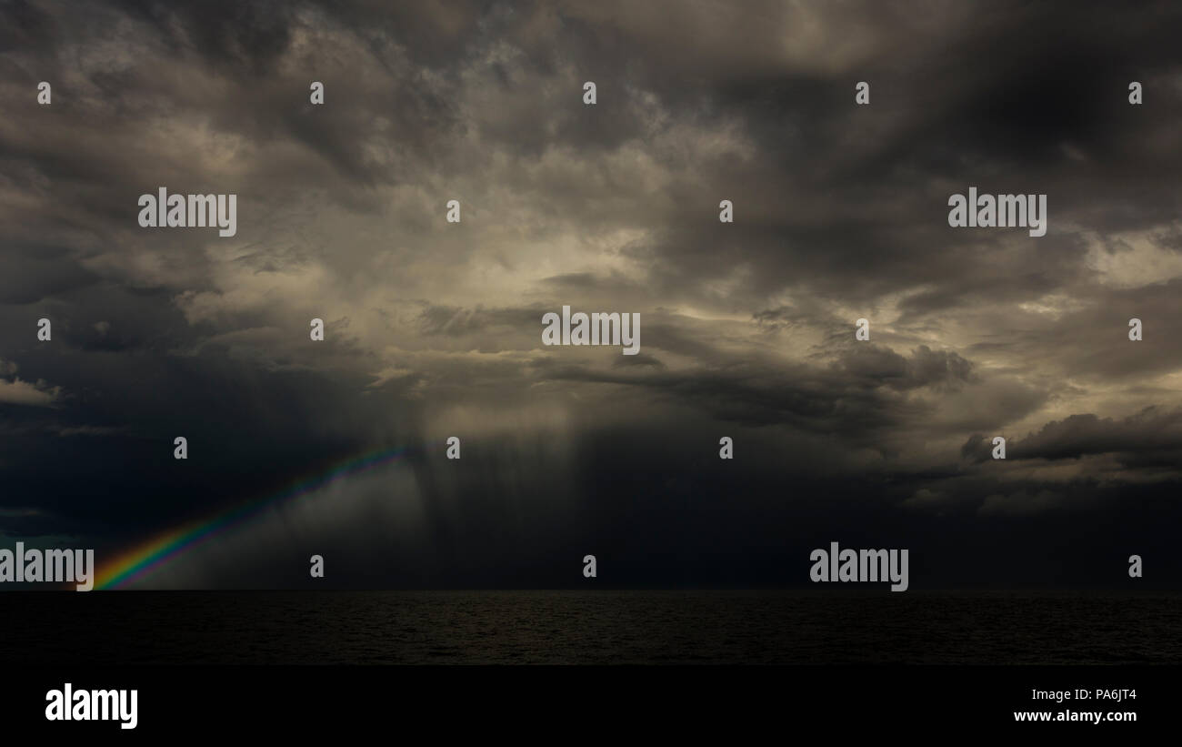 Storm clouds and rainbow over the North Sea Stock Photo