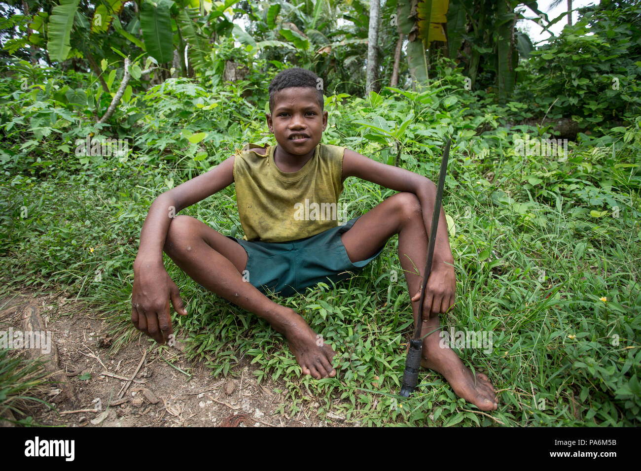 Boy with Machete, Yanaba Island, Papua New Guinea Stock Photo