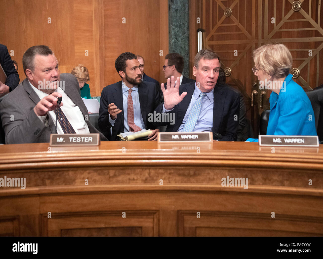 United Staters Senators Jon Tester (Democrat of Montana), left, Mark Warner (Democrat of Virginia), center, and Elizabeth Warren (Democrat of Massachusetts), right, prior to hearing Kathleen Laura Kraninger testify before the United States Senate Committee on Basnking, Housing and Urban Affairs on her nomination to be Director, Bureau of Consumer Financial Protection (CFPB) on Capitol Hill in Washington, DC on Thursday, July 19, 2018. Credit: Ron Sachs/CNP | usage worldwide Stock Photo