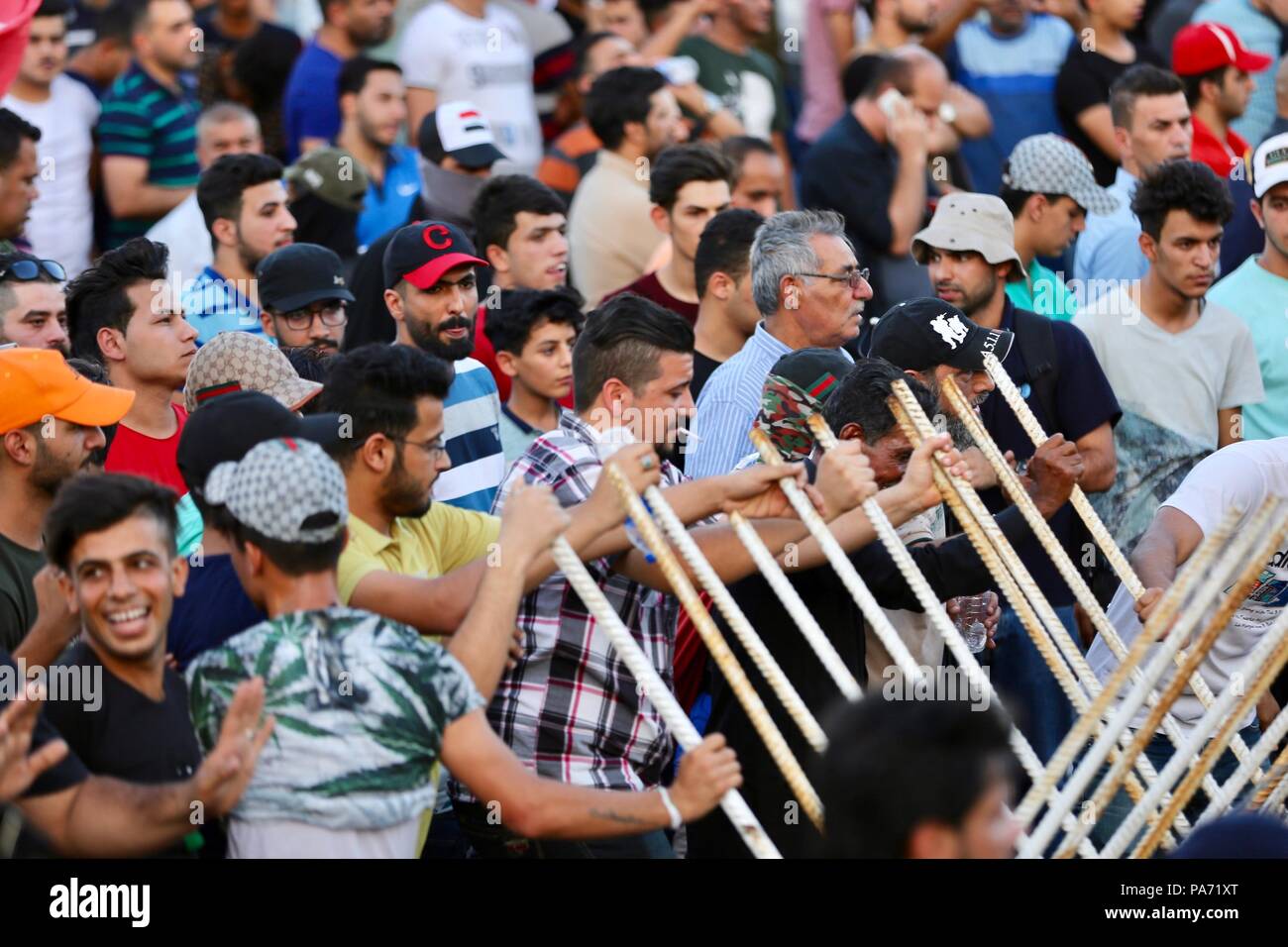 Baghdad, Iraq. 20th July, 2018. Protesters take part in a rally in Baghdad, Iraq, on July 20, 2018. Hundreds of angry protesters took to the streets in Baghdad and southern Iraqi provinces on Friday demanding jobs and better basic services. Credit: Khalil Dawood/Xinhua/Alamy Live News Stock Photo