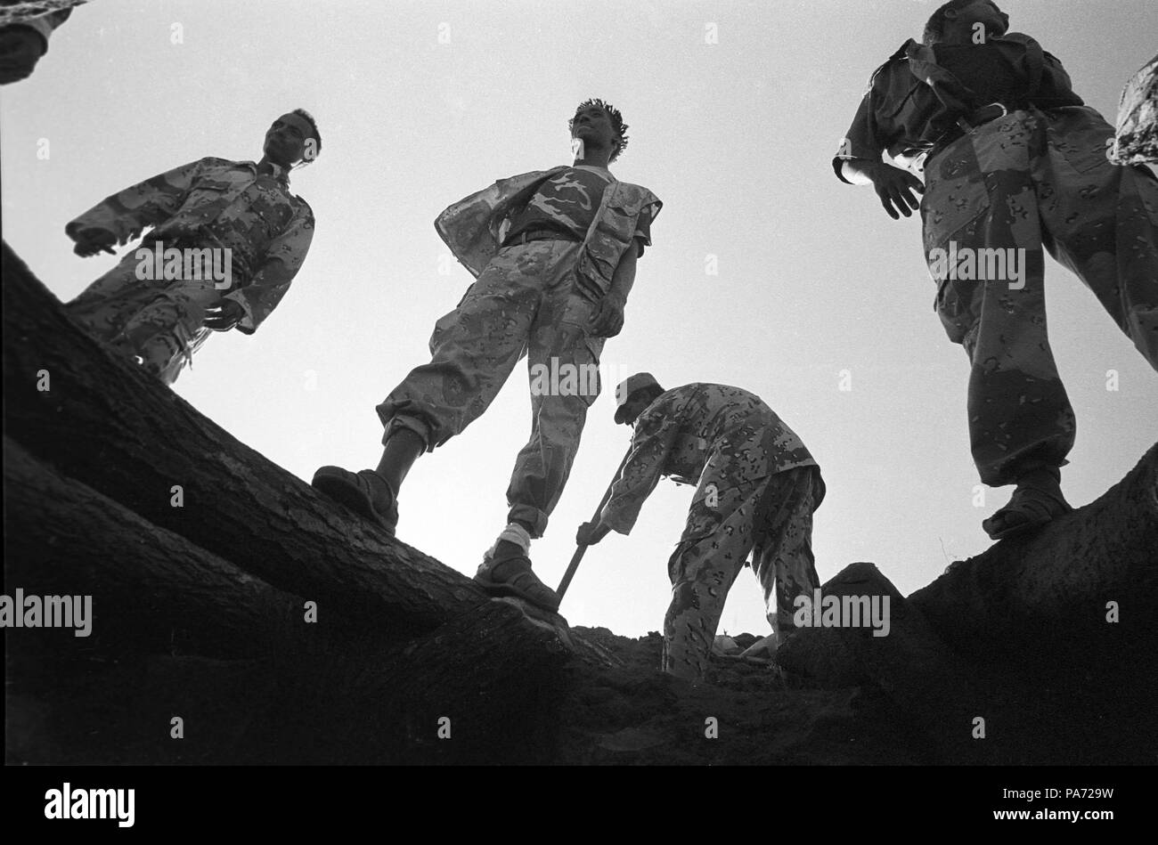 Tserona, Eritrea. 2nd Nov, 1999. In late afternoon, Eritrean soldier reinforce bunkers at the Egri Mikhail on the Ethopian-Eritrean border. The fighters rest during the day when the desert heat is too strong. Eritrea has 620 miles of hand-dug trenches along it's borders. Credit: Cheryl Hatch/ZUMAPRESS.com/Alamy Live News Stock Photo