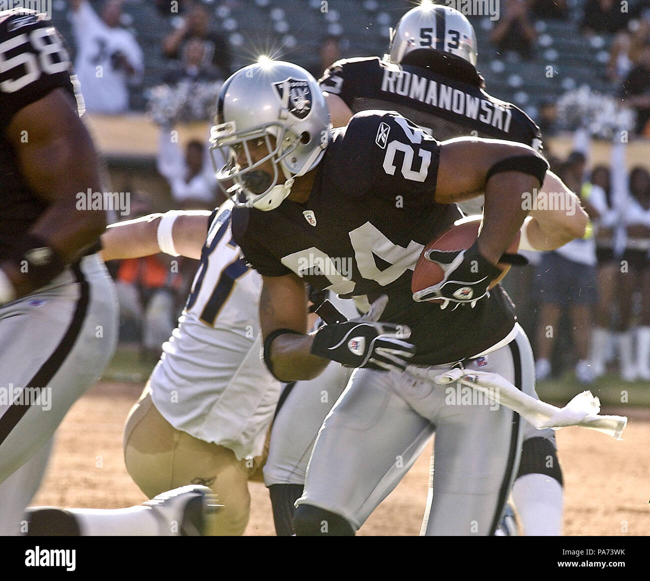 Oakland, California, USA. 8th Aug, 2003. Oakland Raiders defensive back Charles  Woodson (24) holds on to the ball. The Raiders defeated the Rams 7-6 in a  preseason game. Credit: Al Golub/ZUMA Wire/Alamy