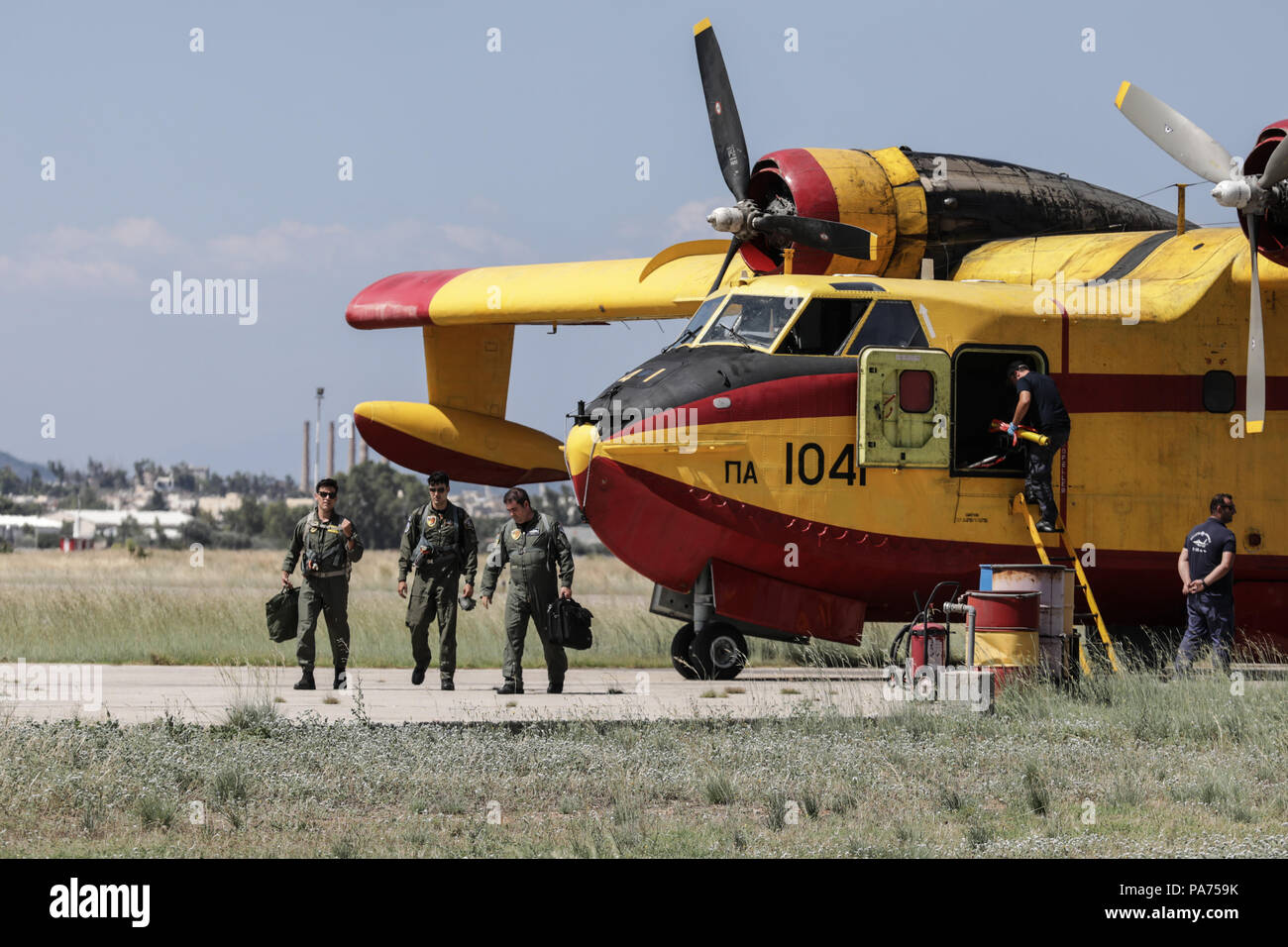 Athens, Greece. 20th July, 2018. Pilots leave a firefighting aircraft at Elefsina Air Base, Athens, Greece, on July 20, 2018. The 355 Tactical Transport Squadron was established in 1947 to fight wildfires. Credit: Lefteris Partsalis/Xinhua/Alamy Live News Stock Photo