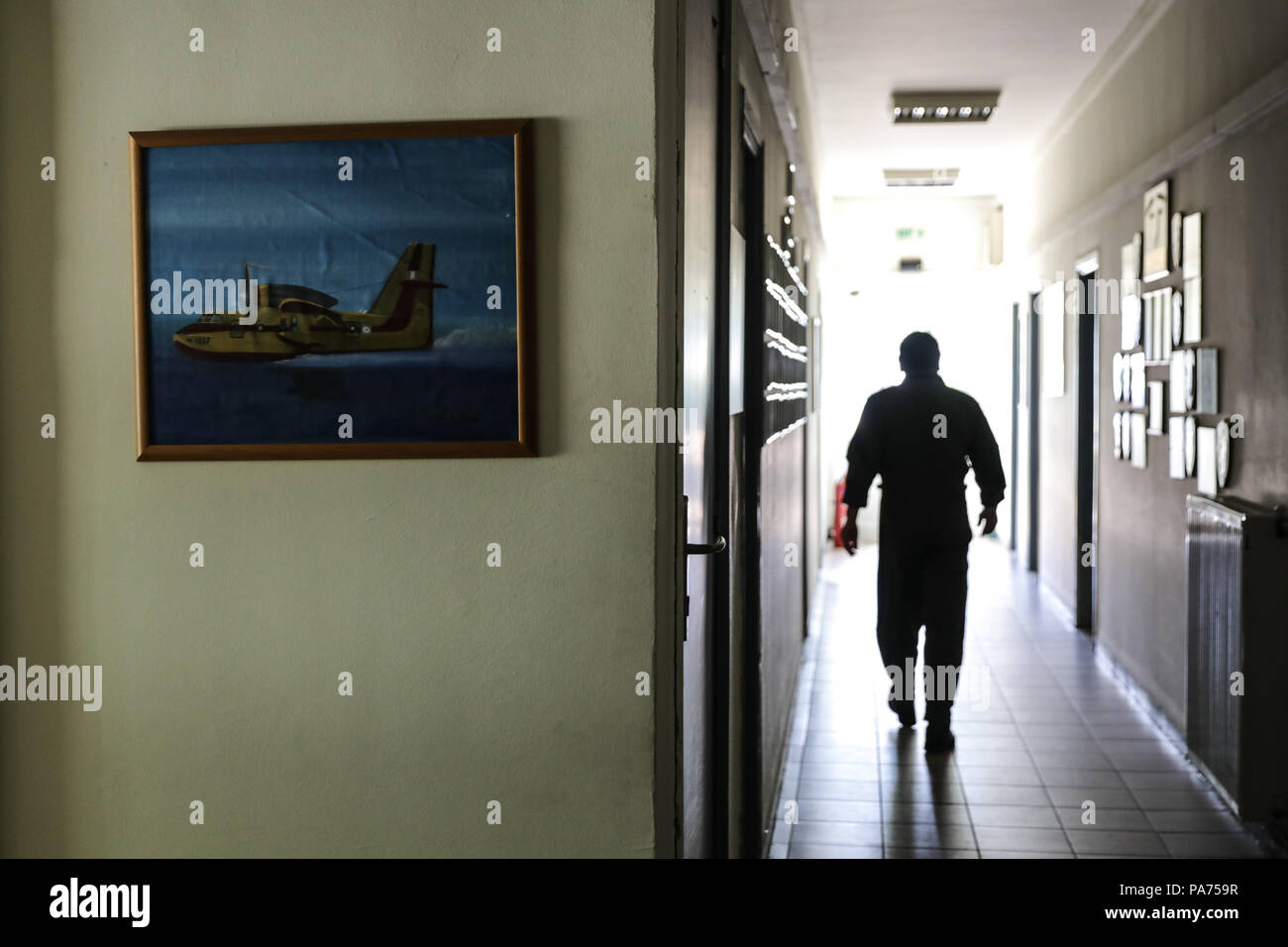 Athens, Greece. 20th July, 2018. Operations officer Fotis Gavrilis walks in the building of 355 Tactical Transport Squadron at Elefsina Air Base, Athens, Greece, on July 20, 2018. The 355 Tactical Transport Squadron was established in 1947 to fight wildfires. Credit: Lefteris Partsalis/Xinhua/Alamy Live News Stock Photo