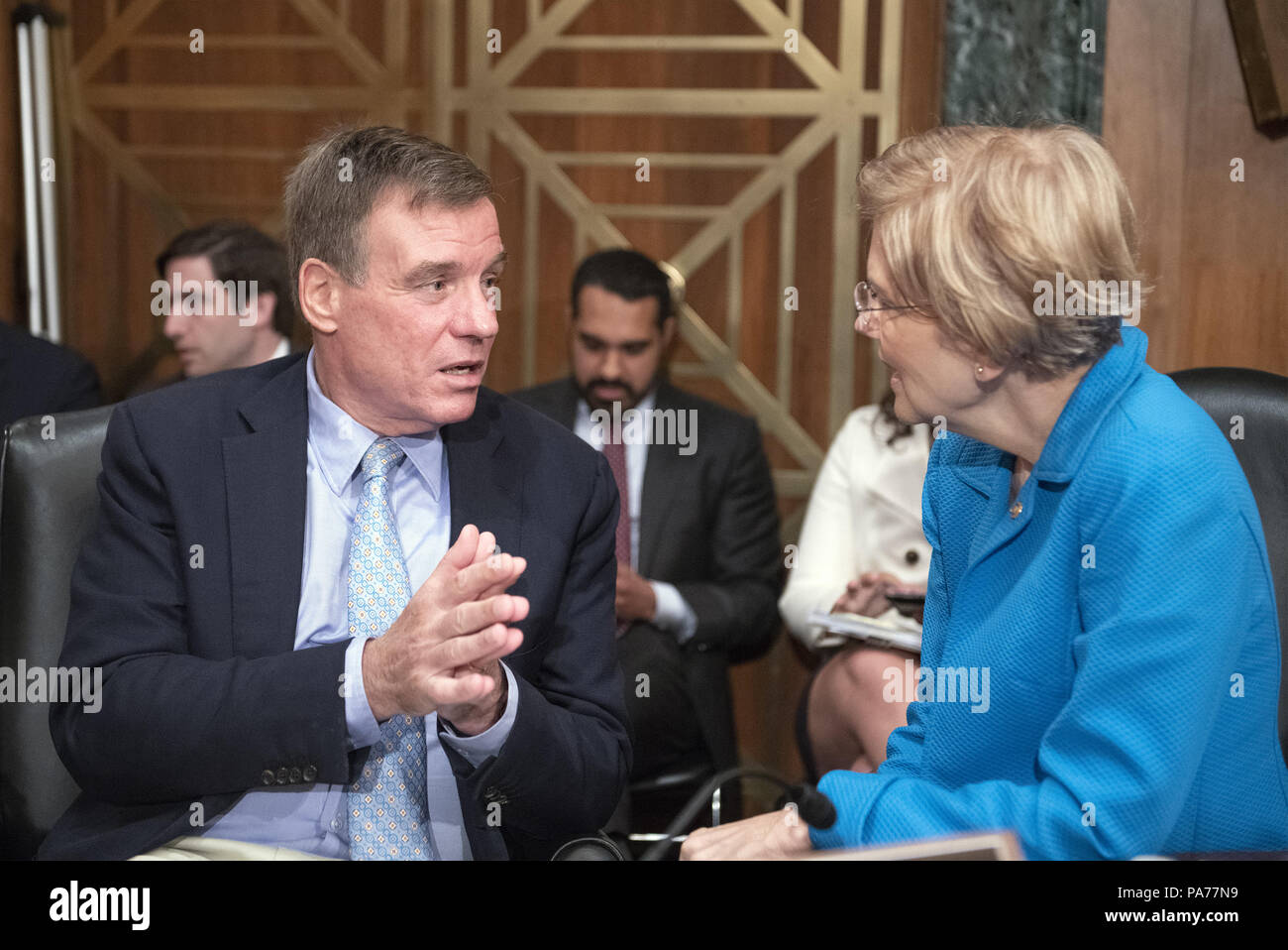 July 19, 2018 - Washington, District of Columbia, United States of America - United States Senators Mark Warner (Democrat of Virginia), left, and Elizabeth Warren (Democrat of Massachusetts), right, converse prior to hearing testimony from Kathleen Laura Kraninger, on her nomination to be Director, Bureau of Consumer Financial Protection (CFPB), and Kimberly A. Reed on her nomination to be President, Export-Import Bank, before the US Senate Committee on Banking, Housing and Urban Affairs on Capitol Hill in Washington, DC on Thursday, July 19, 2018.Credit: Ron Sachs/CNP (Credit Image: © Ron Stock Photo