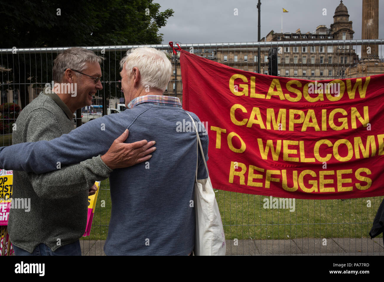 Glasgow, Scotland, on 21 July 2018. A counter demonstration by United Against Facism supporters, during a protest by the far right Scottish Defence League, in George Square, Glasgow, Scotland.  Mounted police and police with dogs separated the two groups as the Scottish Defence League espoused their anti-immigrant rhetoric and accused immigrants of running grooming gangs. Image credit: Alamy News. Stock Photo