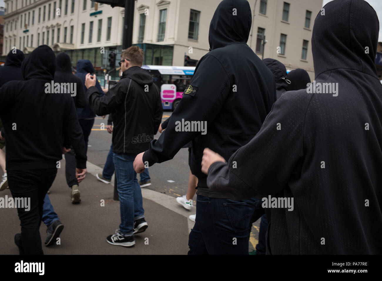 Glasgow, Scotland, on 21 July 2018. A demonstration by anarchists, during a protest by the far right Scottish Defence League, in George Square, Glasgow, Scotland.  Mounted police and police with dogs separated the groups as the Scottish Defence League espoused their anti-immigrant rhetoric and accused immigrants of running grooming gangs. Image credit: Alamy News. Stock Photo