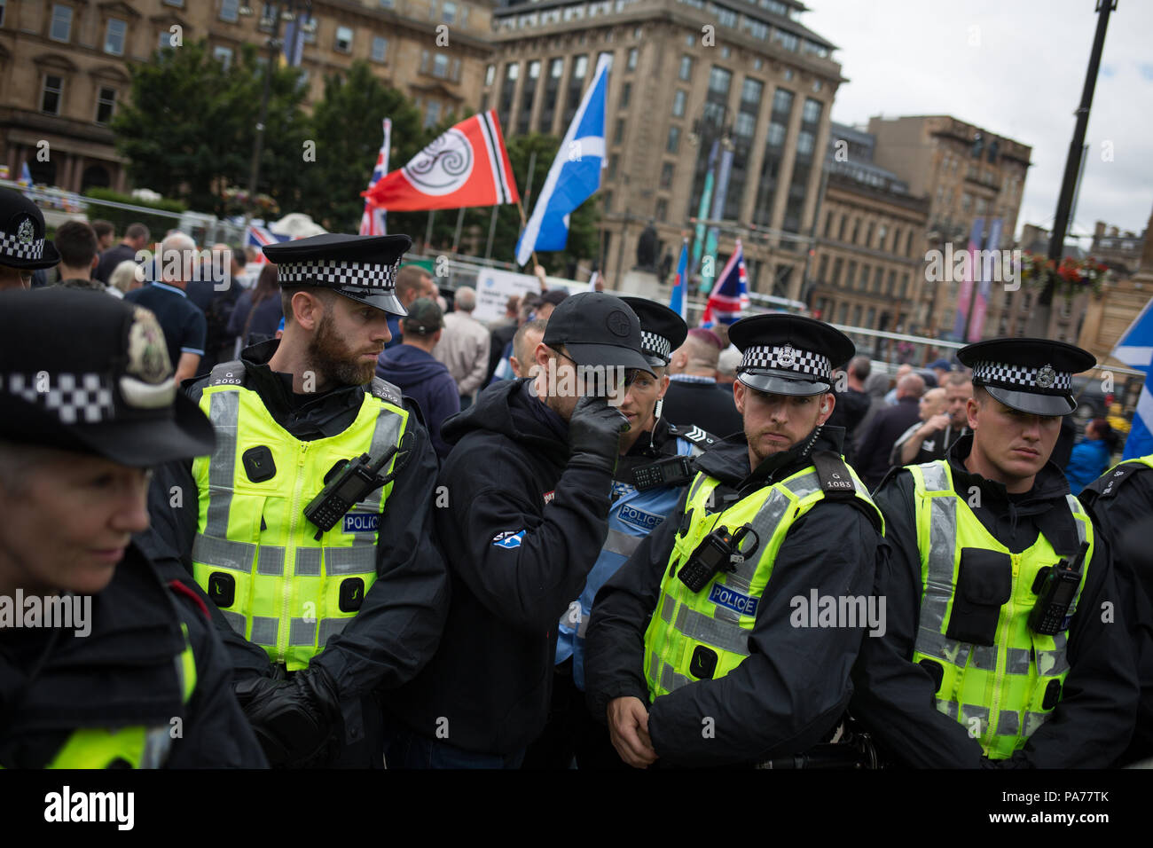 Glasgow, Scotland, on 21 July 2018. A protest by the far right Scottish Defence League, and counter demonstration by the United Against Facism groups, in George Square, Glasgow, Scotland.  Mounted police and police with dogs separated the two groups as the Scottish Defence League espoused their anti-immigrant rhetoric and accused immigrants of running grooming gangs. Image credit: Alamy News. Stock Photo