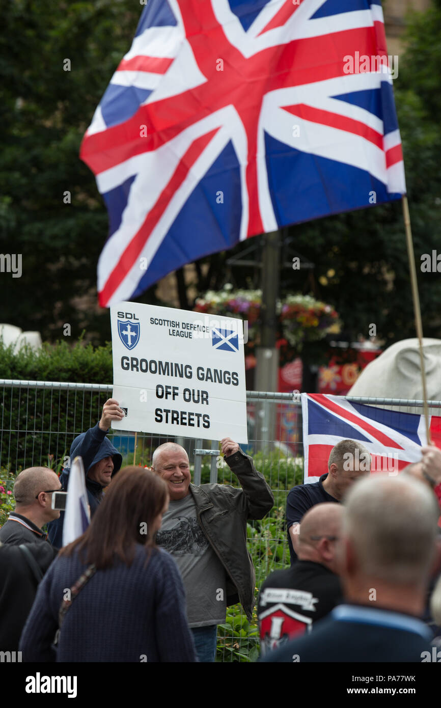 Glasgow, Scotland, on 21 July 2018. A protest by the far right Scottish Defence League, and counter demonstration by the United Against Facism groups, in George Square, Glasgow, Scotland.  Mounted police and police with dogs separated the two groups as the Scottish Defence League espoused their anti-immigrant rhetoric and accused immigrants of running grooming gangs. Image credit:  Alamy News. Stock Photo