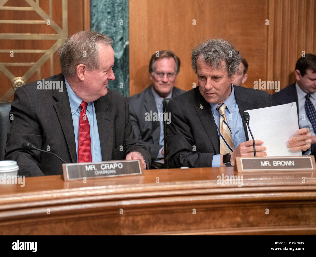 United States Senators Mike Crapo (Republican of Idaho), left, Chairman, US Senate Committee on Banking, Housing and Urban Affairs, left, and Sherrod Brown (Democrat of Ohio), right, Ranking Member, converse prior to hearing testimony from Kathleen Laura Kraninger, on her nomination to be Director, Bureau of Consumer Financial Protection (CFPB), and Kimberly A. Reed on her nomination to be President, Export-Import Bank, before the on Capitol Hill in Washington, DC on Thursday, July 19, 2018. Credit: Ron Sachs/CNP /MediaPunch Stock Photo