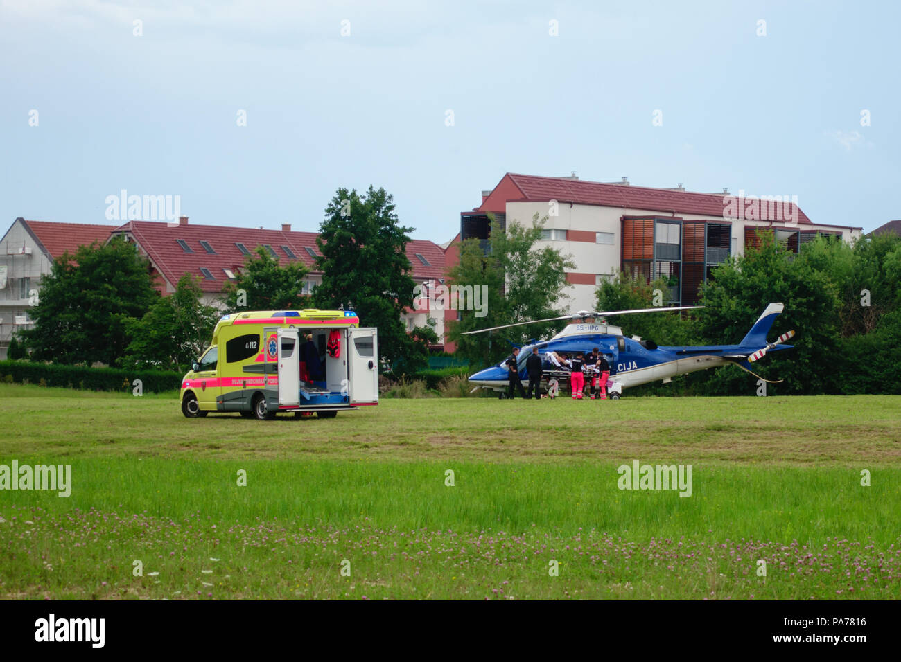 Slovenska Bistrica, July 21 2018: Paramedics hand over patient to Police helicopter for emergency aerial transport to hospital. Ambulance car with flashing lights. Live news. Credit: Andrej Safaric/Alamy Live News Stock Photo