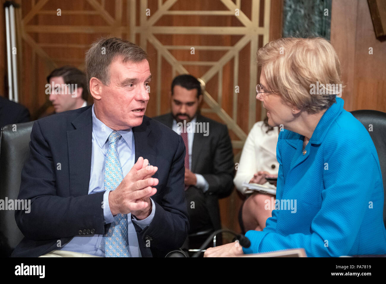 United States Senators Mark Warner (Democrat of Virginia), left, and Elizabeth Warren (Democrat of Massachusetts), right, converse prior to hearing testimony from Kathleen Laura Kraninger, on her nomination to be Director, Bureau of Consumer Financial Protection (CFPB), and Kimberly A. Reed on her nomination to be President, Export-Import Bank, before the US Senate Committee on Banking, Housing and Urban Affairs on Capitol Hill in Washington, DC on Thursday, July 19, 2018. Credit: Ron Sachs/CNP /MediaPunch Stock Photo