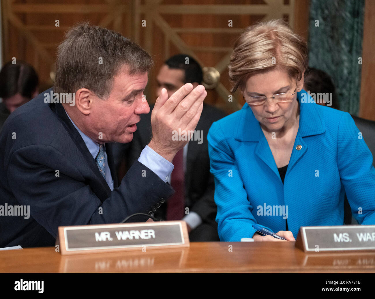 United States Senators Mark Warner (Democrat of Virginia), left, and Elizabeth Warren (Democrat of Massachusetts), right, converse prior to hearing testimony from Kathleen Laura Kraninger, on her nomination to be Director, Bureau of Consumer Financial Protection (CFPB), and Kimberly A. Reed on her nomination to be President, Export-Import Bank, before the US Senate Committee on Banking, Housing and Urban Affairs on Capitol Hill in Washington, DC on Thursday, July 19, 2018. Credit: Ron Sachs/CNP /MediaPunch Stock Photo