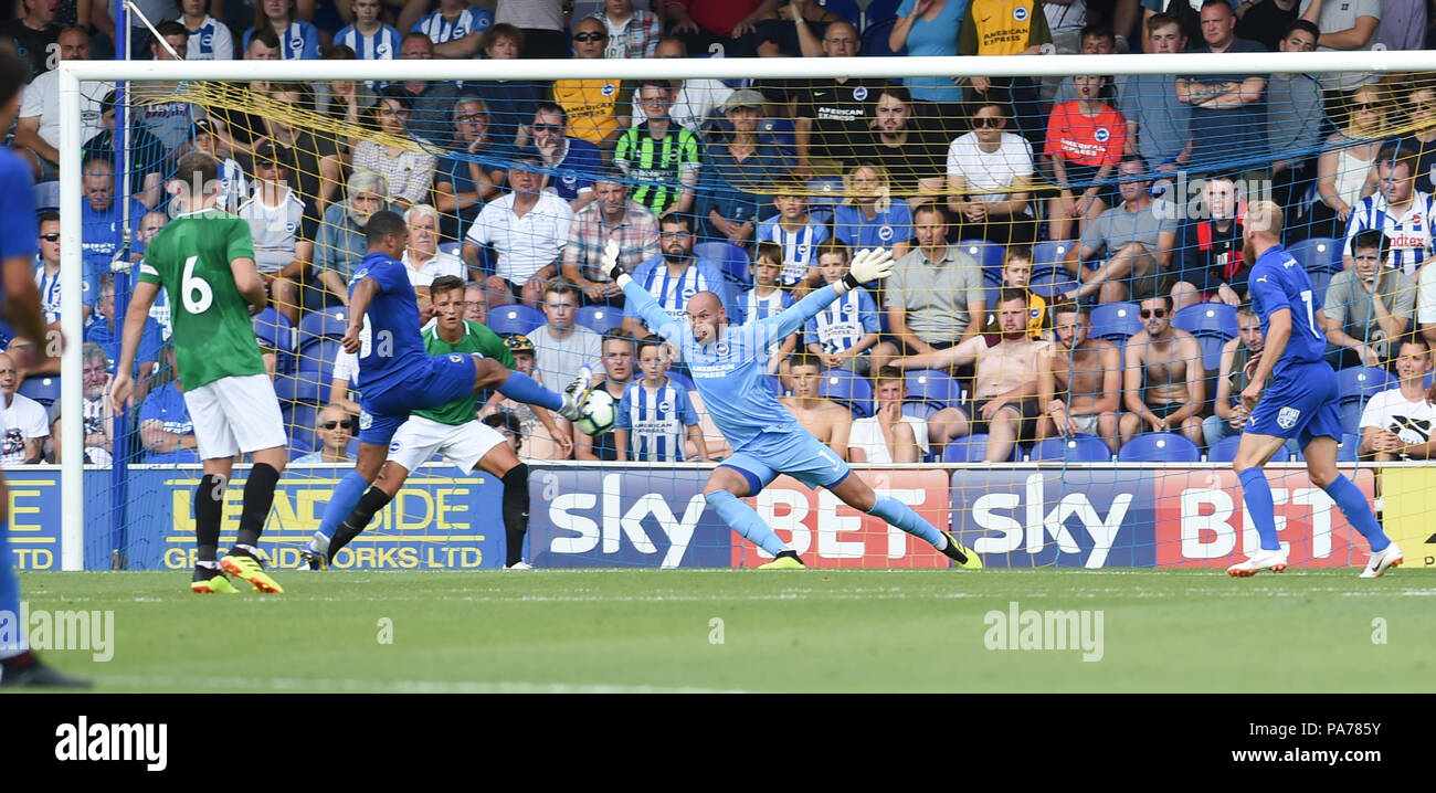 Kingston London UK 21st July 2018 - Kwesi Appiah of Wimbledon scores their second goal past Brighton keeper David Button during the pre season friendly football match between AFC Wimbledon and Brighton and Hove Albion  at the Cherry Red Records Stadium in Kingston Surrey Photograph taken by Simon Dack Credit: Simon Dack/Alamy Live News - Editorial Use Only Stock Photo