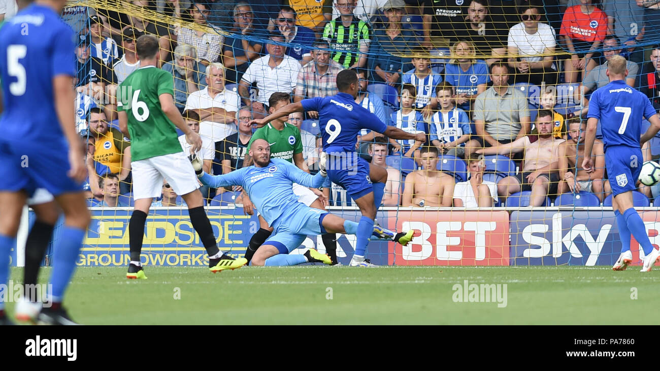 Kingston London UK 21st July 2018 - Kwesi Appiah of Wimbledon scores their second goal past Brighton keeper David Button during the pre season friendly football match between AFC Wimbledon and Brighton and Hove Albion  at the Cherry Red Records Stadium in Kingston Surrey Photograph taken by Simon Dack Credit: Simon Dack/Alamy Live News - Editorial Use Only Stock Photo