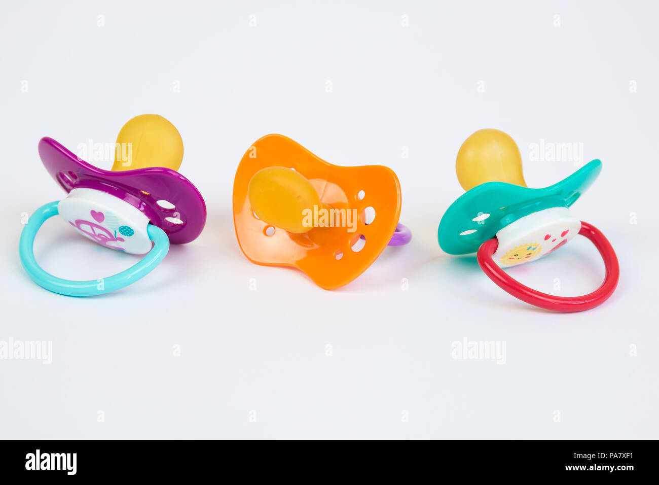 Three Cute Baby pacifiers with rubber head isolated on white background Stock Photo