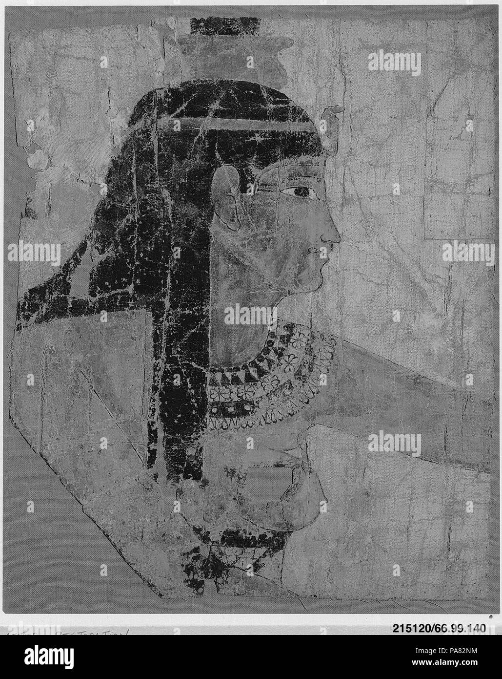 Painted Shroud Fragment. Dimensions: H. 38 cm (14 15/16 in); W. 30.2 cm (11 7/8 in); Framed: H. 44 cm (17 5/16 in.); W. 36 cm (14 3/16 in.); D. 4.4 cm (1 3/4 in.). Date: 1st century BC-1st century AD.  As wife and sister of Osiris, Isis and Nephthys were twinned in funerary beliefs. These heads of the two goddesses, 66.99.140 and 66.99.141,  come from a single linen shroud, which probably showed them raising their arms in a gesture of care and reverence on either side of the frontal, mummified image of Osiris. When wrapped about the mummy, the images on the shroud would have identified the dec Stock Photo