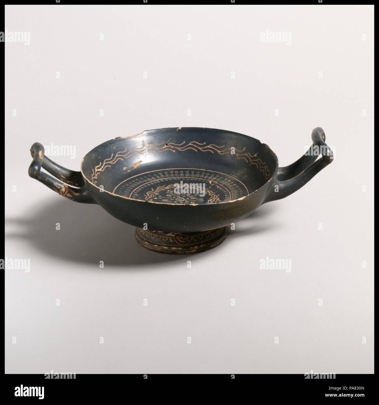 Terracotta kylix (drinking cup). Culture: Greek, South Italian, Campanian, Teano. Dimensions: diameter  5in. (12.7cm). Date: ca. 330-300 B.C..  Decorated with ivy vine and stamped pattern. Museum: Metropolitan Museum of Art, New York, USA. Stock Photo