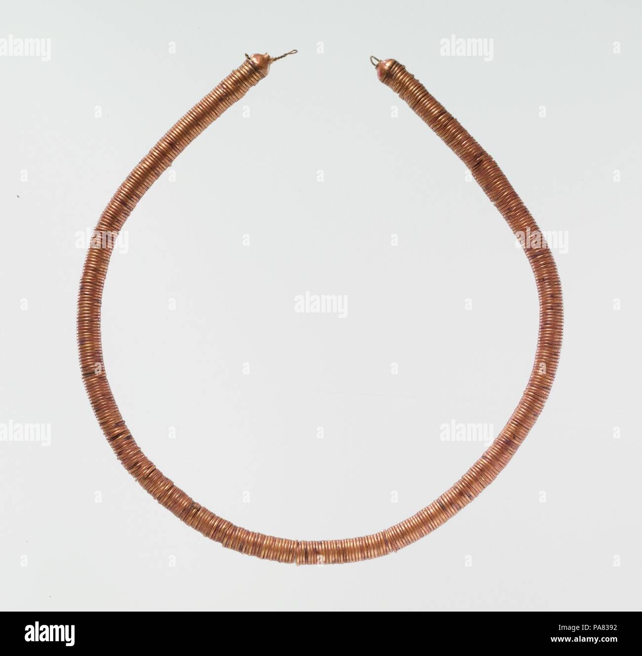 Choker of Gold Rings. Dimensions: L. 33.5 cm (13 3/16 in); rings d. 0.6 cm (1/4 in). Dynasty: Dynasty 17-Early Dynasty 18. Date: ca. 1635-1458 B.C..  Chokers like this one are uncommon and seem to come from around Thebes; the earliest example is from a Dynasty 11 (ca. 2040 B.C.) burial. By the beginning of Dynasty 18, they were worn in multiple strings. These short necklaces are often referred to as shebiu, even though they do not resemble the traditional necklaces of lentoid beads called shebiu collars that the king awarded courtiers. Furthermore, several examples come from female burials and Stock Photo