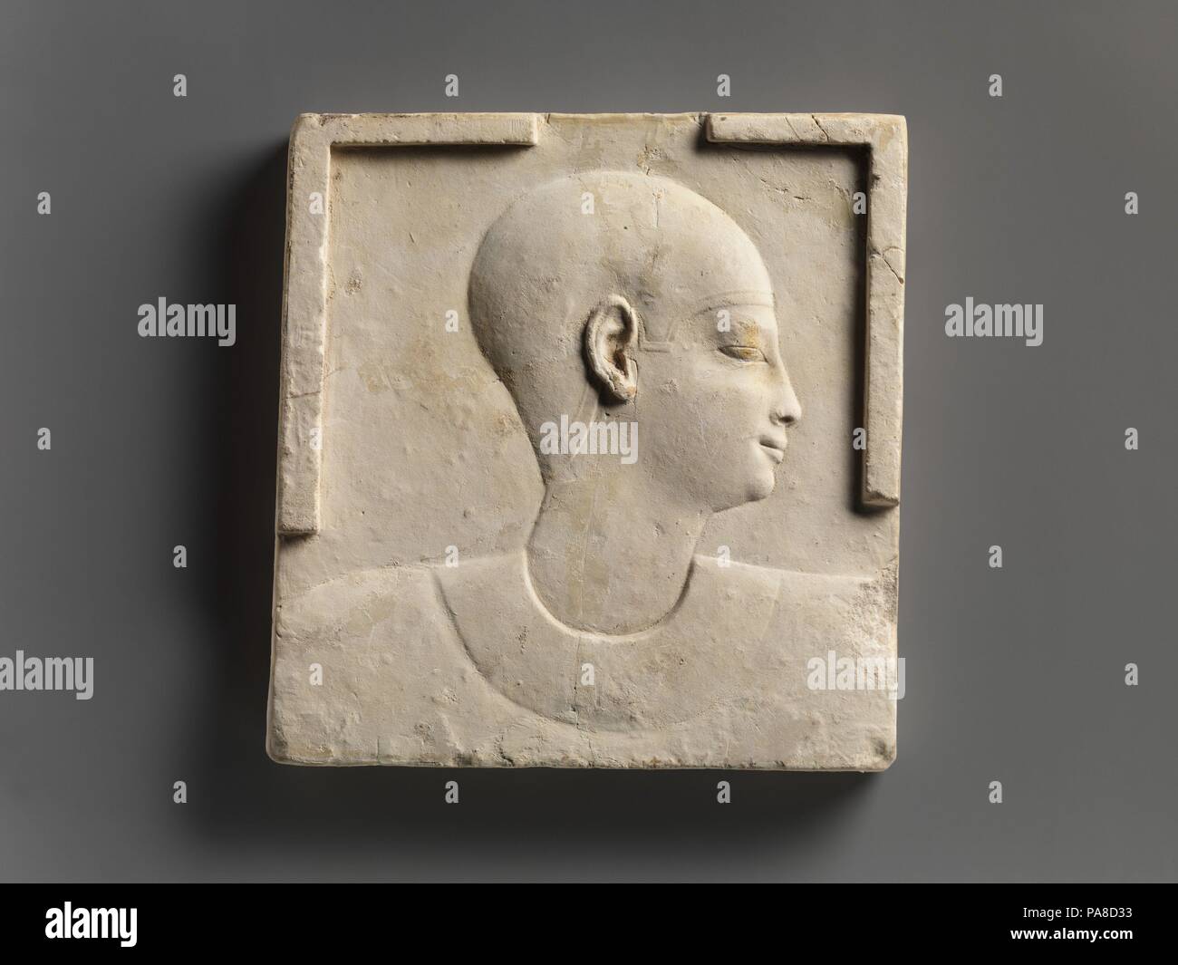 Plaque with head and shoulders of a priestly figure, opposite side head