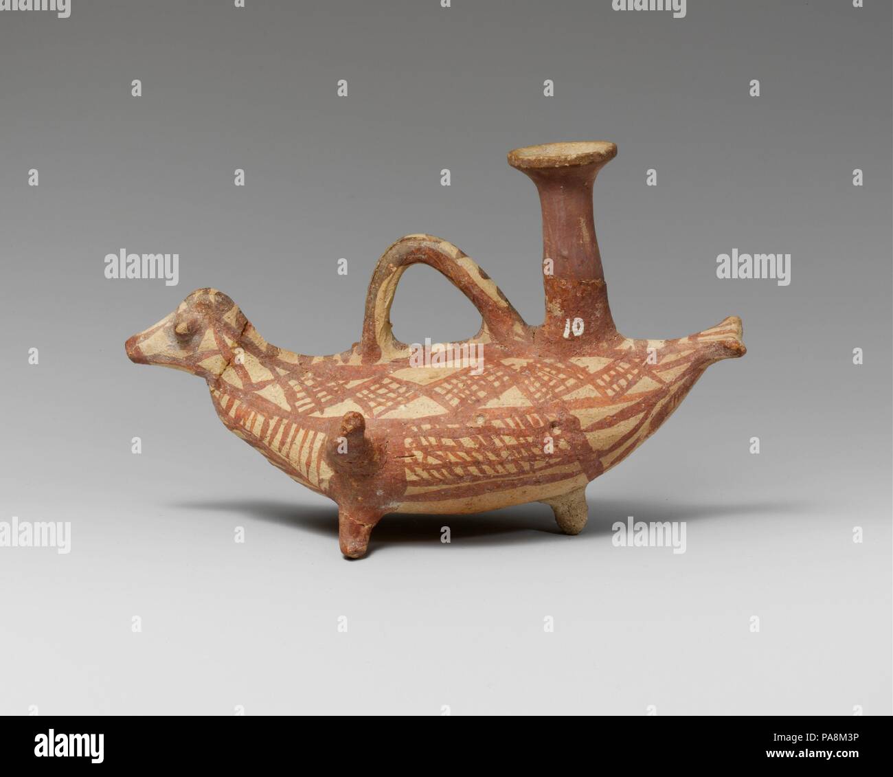 Terracotta askos (flask with a spout and handle over the top) in the form of a bird. Culture: Cypriot. Dimensions: H. 4 7/16 in. (11.3 cm). Date: 1200-1050 B.C..  Three feet, with tubular spout and geometric ornament. Museum: Metropolitan Museum of Art, New York, USA. Stock Photo