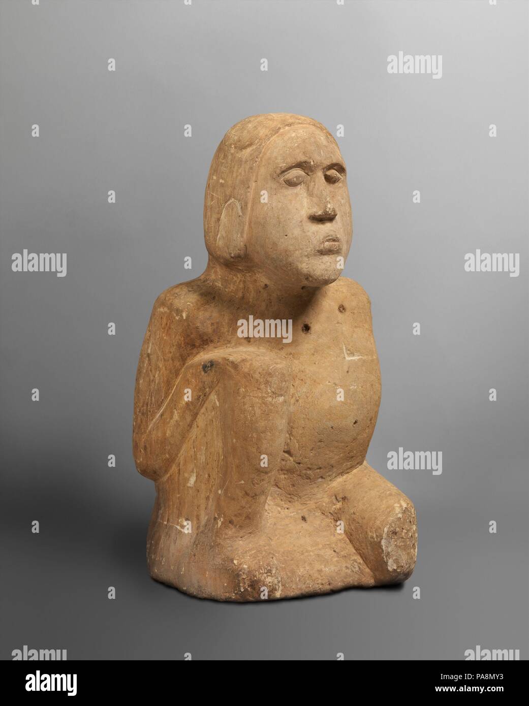 Mississippian Figure. Culture: Mississippian. Dimensions: H. 26 1/2 x W. 14 x D. 10 3/4 in. (67.3 x 35.6 x 27.3 cm)  Weight: 93 lbs.. Date: 13th-14th century.  This ancestral figure was one of a male-female pair when discovered in 1895 on the banks of the Duck River in Humphreys County, Tennessee. Such figures played important roles among the more complex Mississippian societies of the Southeast during later precolonial times, when they were the focus of ancestor cults. The figures, primarily but not exclusively male, were placed and venerated in shrine houses together with the bones of signif Stock Photo