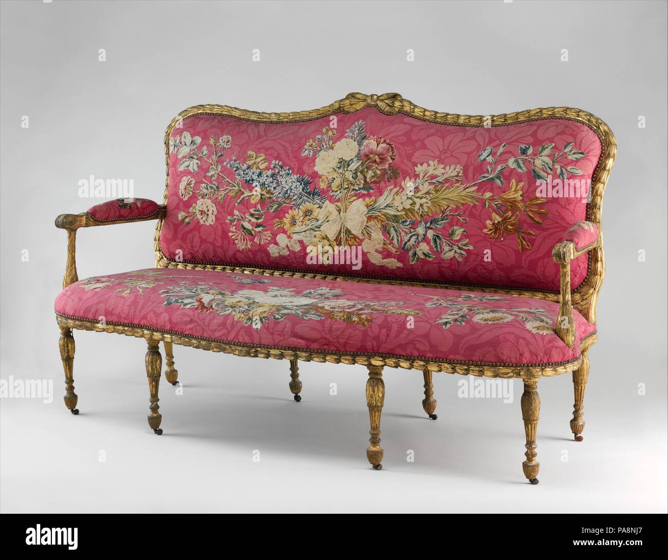 Settee (one of a pair). Culture: British and French. Designer: Tapestry designed by Maurice Jacques (French, 1712-1784). Dimensions: 44 × 75 × 32 1/2 in. (111.8 × 190.5 × 82.6 cm). Factory: Tapestry woven at Manufacture Nationale des Gobelins (French, established 1662). Maker: Workshop of Jacques Neilson (French, 1714-1788); John Mayhew (British, 1736-1811); and William Ince (British, active ca. 1758/59-1794, died 1804). Patron: Commissioned for George William Coventry, 6th earl of Coventry (Croome Court, Worcestershire, England). Date: 1769-71.  This settee and its mate (58.75.22) were made f Stock Photo