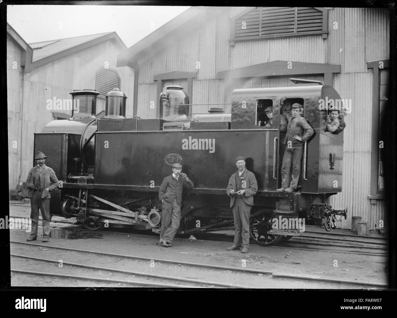 109 H class steam locomotive, NZR 199, 0-4-2T type, for use on the Fell system on the Rimutaka Incline, with a group of men standing on and beside the engine. ATLIB 285802 Stock Photo