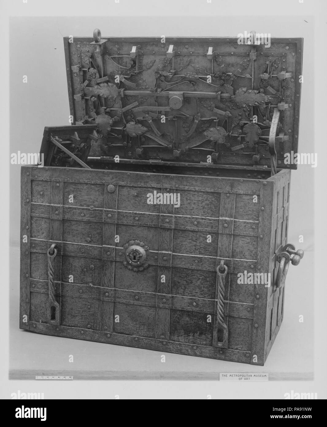Strongbox. Culture: German, possibly Nuremberg. Dimensions: Overall (confirmed): 35 3/4 × 51 in., 768 lb. (90.8 × 129.5 cm, 348.4 kg). Date: late 16th or early 17th century.  This formidable steel strongbox is reinforced with an armature of the same material. Its elaborate locking mechanism, consisting of nine bolts and various leaf-shaped shields, offered the owner a safe storage place for his valuables. Corresponding to the eyes along the rim of the lid, the two pendant hasps in front allowed the use of additional padlocks. Nuremberg and the neighboring town of Augsburg were major metal-prod Stock Photo