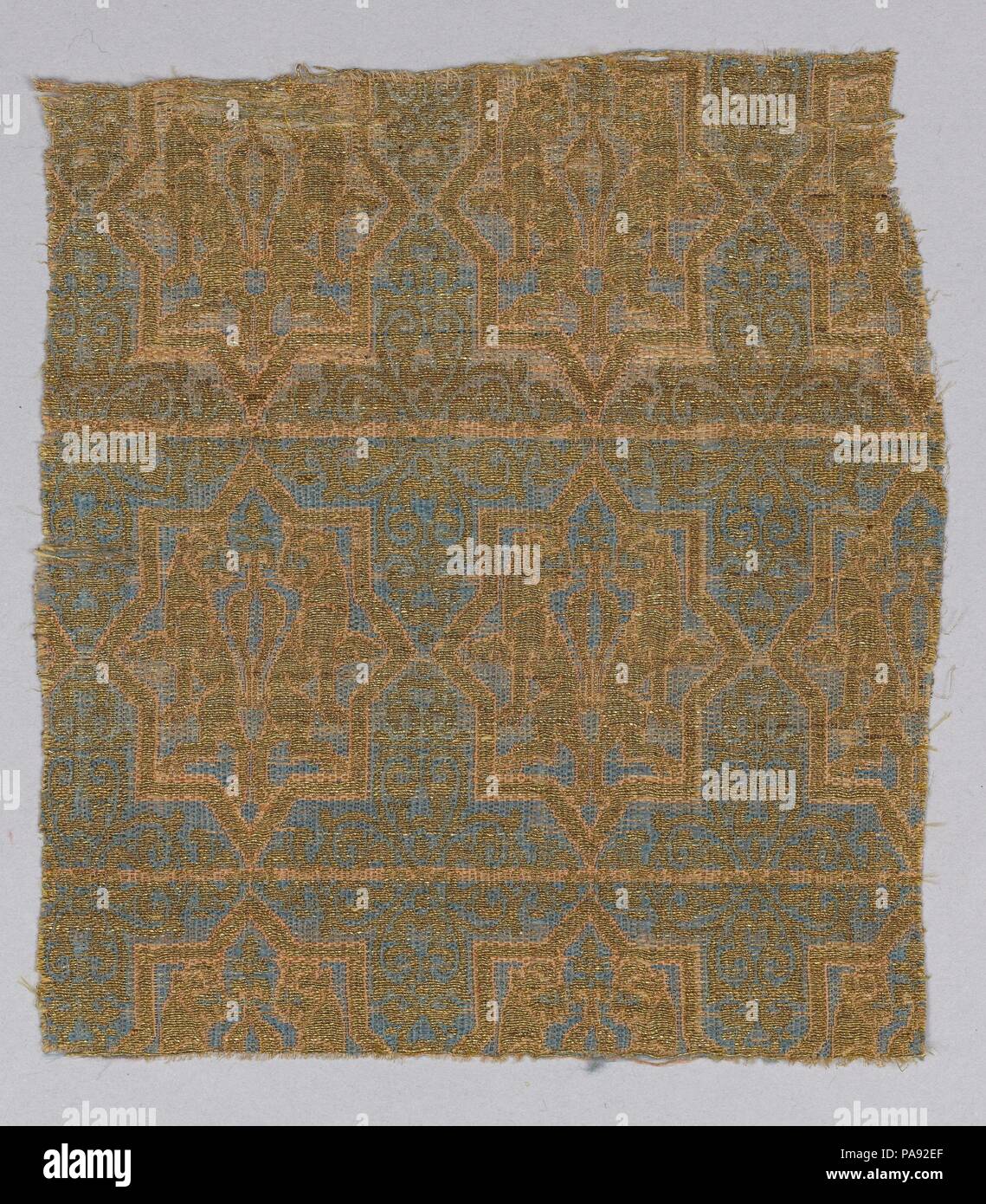 Textile Fragment from the Chasuble of San Valerius. Dimensions: Textile: L. 6 in. (15.2 cm)  W. 5 1/4 in. (13.3 cm)  Mount: H. 9 3/4 in. (24.8 cm)  W. 9 1/8 in. (23.2 cm)  D. 1 3/8 in. (3.5 cm). Date: 13th century.  This brocaded textile belongs to a collection of vestments attributed to the cult of Saint Valerius, who was the bishop of Saragossa from 290 until 315. During the eleventh century his body was transferred to the Cathedral of San Vicente de Roda de Isábena in Lerida (Catalonia), from where relics were dispatched to other churches. The textiles were made to venerate the saint, with  Stock Photo