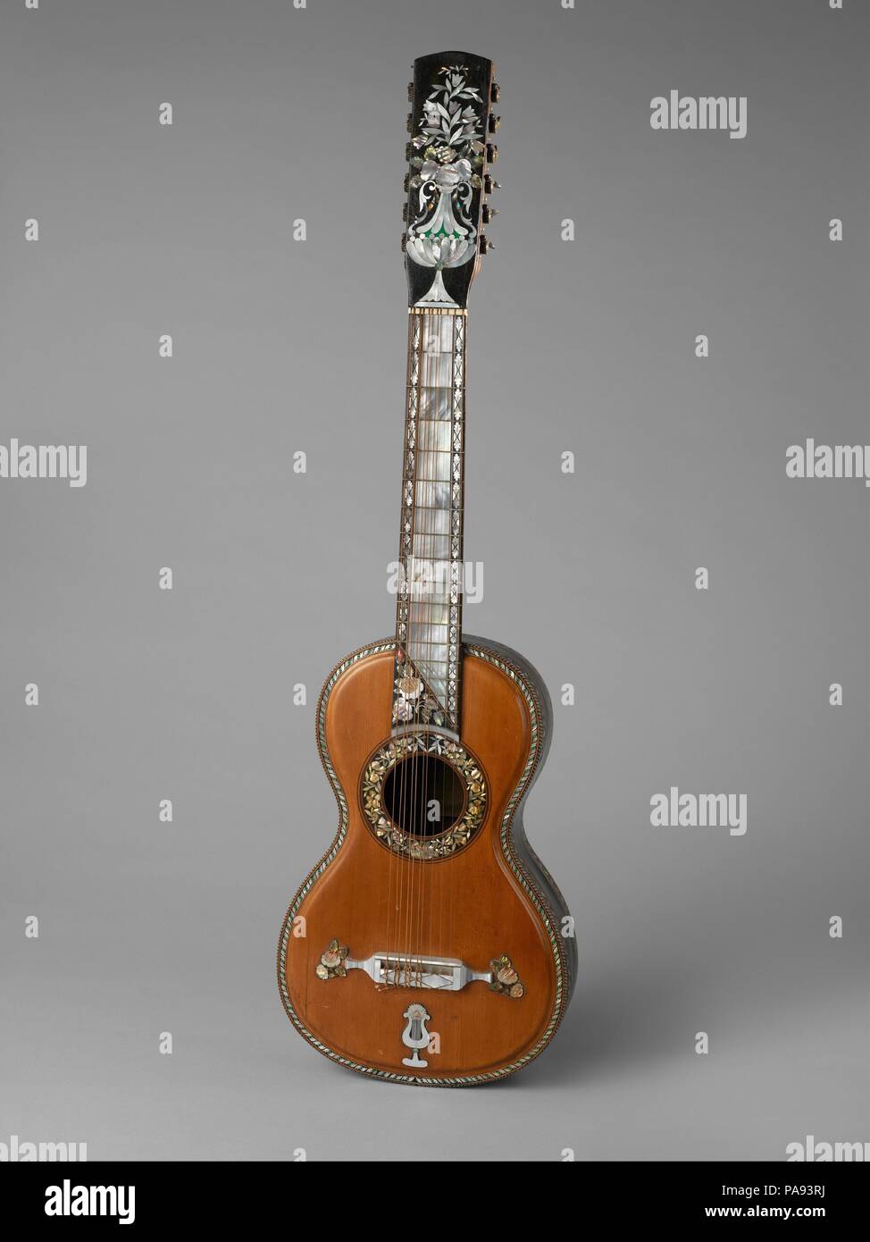 Guitarra septima (seven string guitar). Culture: Mexican. Dimensions: Height: 51 3/8 in. (130.5 cm)  Width: 11 3/4 in. (29.8 cm). Maker: M. Fernandez (Mexican). Date: ca. 1880.  Mariano Fernández, Guitarra Séptima (Seven-course guitar)  2012.569  The Mexican seven-course guitar reached the height of its popularity during the 19th century.  It was used to perform music in a variety of genres, most of it written by Mexican composers. This beautifully crafted instrument by Mariano Fernández epitomizes guitar making in Mexico at its highest level. Inlaid mother-of-pearl, abalone and wood trace int Stock Photo