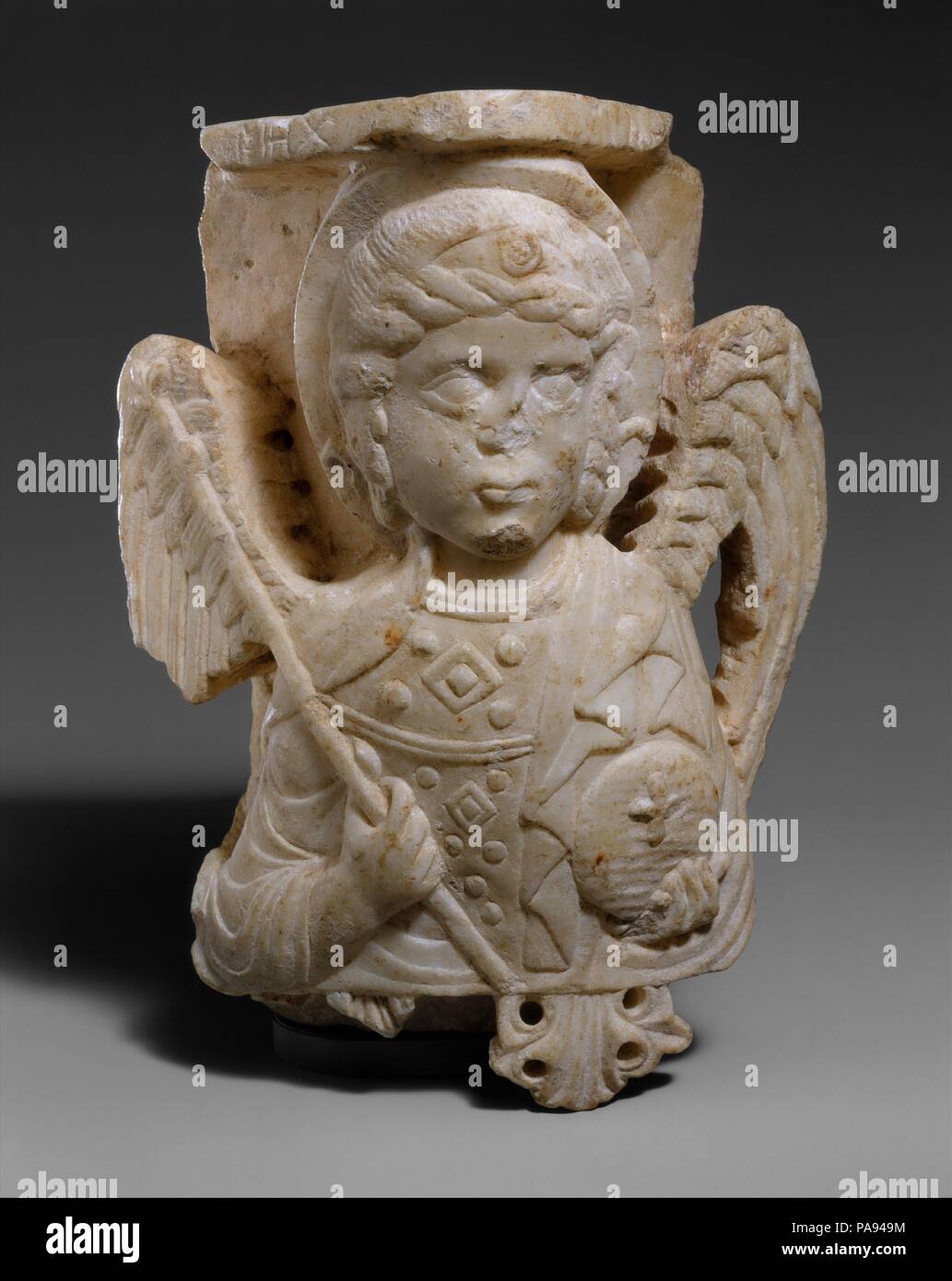 Capital with Bust of the Archangel Michael. Culture: Byzantine. Dimensions: Overall: 10 x 6 3/4 x 4 3/16 in. (25.4 x 17.1 x 10.6 cm). Date: 1250-1300.  This beautifully carved fragment was once part of the interior architecture of a church, perhaps placed at the top of a tomb niche or altar screen. Archangels were often portrayed, as here, in the ceremonial dress of the Byzantine emperor, the head of Christ's earthly court. Museum: Metropolitan Museum of Art, New York, USA. Stock Photo