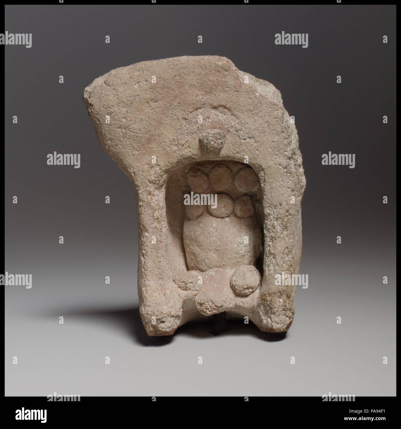 Terracotta model of a shrine. Culture: Cypriot. Dimensions: H. 3 7/8 in. (9.9 cm). Date: ca. 600-480 B.C..  The shrine contains a nonfigural representation, known as a betyl. The crescent and disk above the opening are symbols of the goddess Astarte, to whom the model may have been dedicated. Museum: Metropolitan Museum of Art, New York, USA. Stock Photo