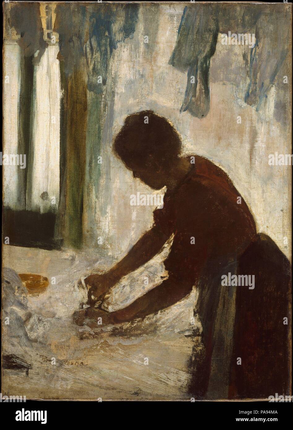 A Woman Ironing. Artist: Edgar Degas (French, Paris 1834-1917 Paris). Dimensions: 21 3/8 x 15 1/2 in. (54.3 x 39.4 cm). Date: 1873.  Much as Degas was fascinated by the movements of dancers, he was also intrigued by the repetitive, specialized gestures made by laundresses as they worked. This painting, the first of three versions of the composition, is distinguished by its dramatic chiaroscuro, with the woman silhouetted against a luminous white backdrop. Purchased by the singer and collector Jean-Baptiste Faure, the canvas was returned so that Degas could rework it. The artist, however, kept  Stock Photo