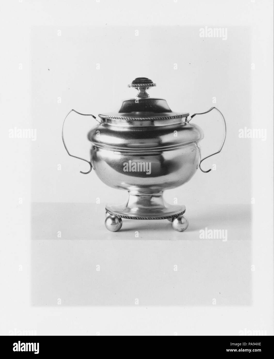 Sugar Bowl. Culture: American. Dimensions: Overall: 7 3/4 x 8 3/8 x 5 1/8 in. (19.7 x 21.3 x 13 cm); 15 oz. 10 dwt. (482 g)  Body: H. 6 3/16 in. (15.7 cm); 12 oz. 3 dwt. (377.9 g)  Cover: 2 1/8 x 4 9/16 x 3 15/16 in. (5.4 x 11.6 x 10 cm); 3 oz. 7 dwt. (104.1 g). Maker: William B. Heyer (active ca. 1807-22). Retailer: Hyde and Nevins (active ca. 1814-19). Date: ca. 1815. Museum: Metropolitan Museum of Art, New York, USA. Stock Photo