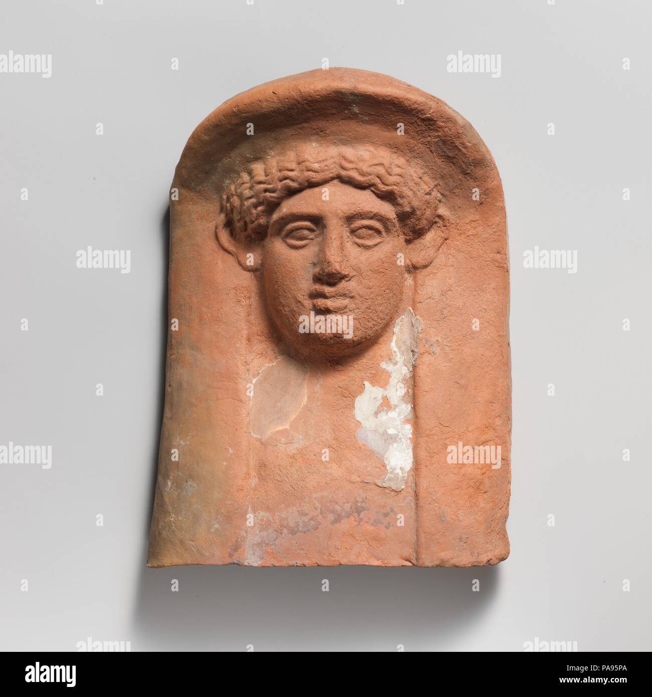 Terracotta relief head of a woman. Culture: East Greek. Dimensions: Overall: 11 1/2 x 8 3/4 in. (29.2 x 22.2 cm). Date: ca. 450-400 B.C..  Mask of a woman. Museum: Metropolitan Museum of Art, New York, USA. Stock Photo